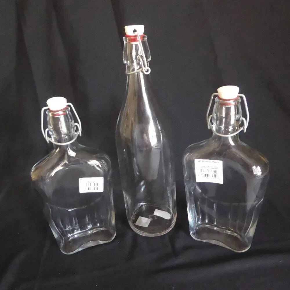 NEW 12.5” - 9.5” CRATE BARREL ITALY CLEAR GLASS AIR TIGHT LOCKING TOP 3 BOTTLES